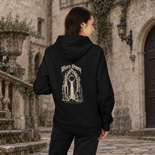 AFTERLIGHT black hoodie worn from the back in a stone courtyard