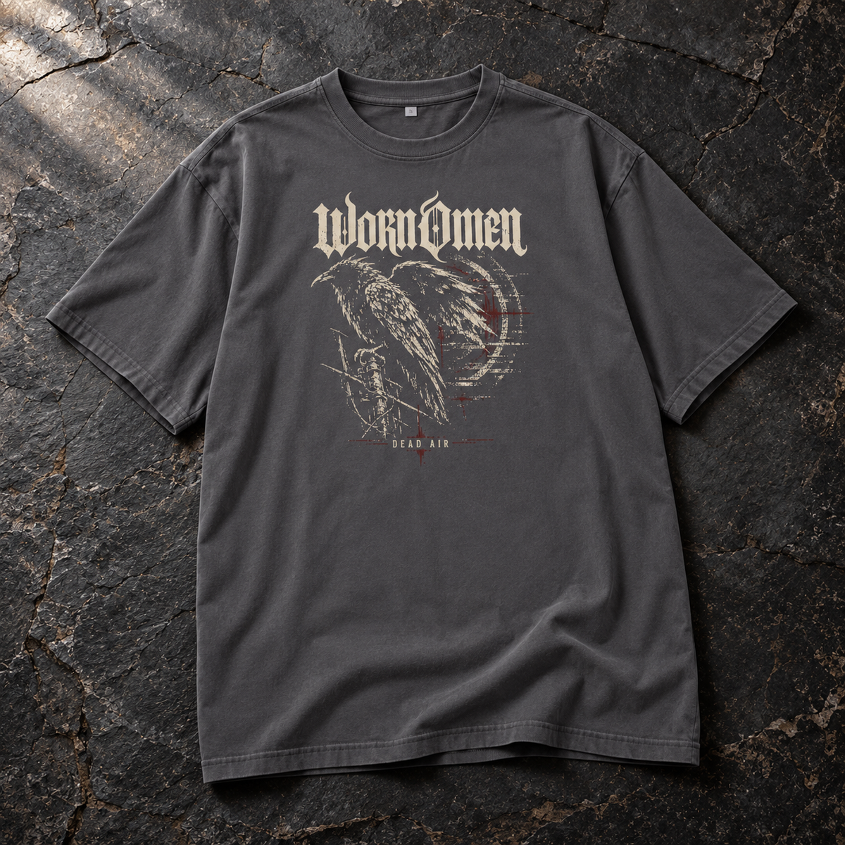 WORN OMEN Dead Air Magnet-grey oversized tee with raven front print, laid on dark slate
