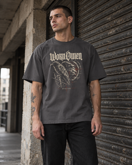 Model wearing the Dead Air tee with bone and oxblood raven artwork on the front