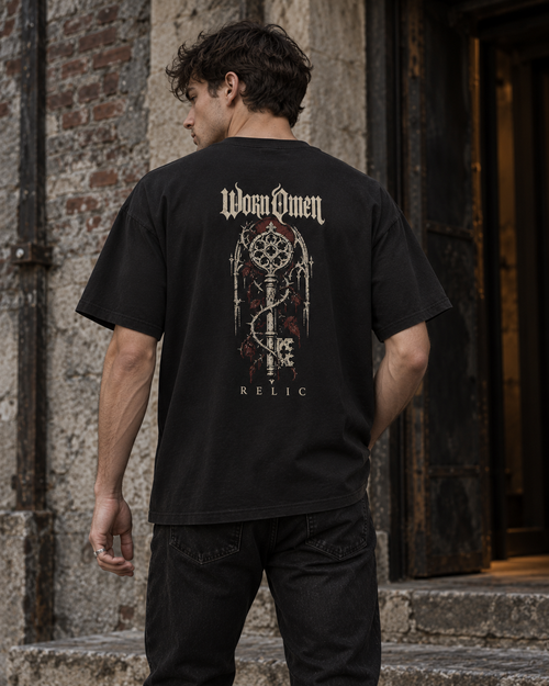 Back view of a model wearing the Relic tee with the gothic key print